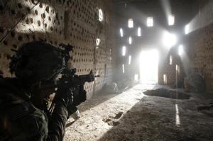 U.S. soldier Nicholas Dickhut from 5-20 infantry Regiment attached to 82nd Airborne points his rifle at a doorway after coming under fire by the Taliban while on patrol in Zharay district in Kandahar province, southern Afghanistan April 26, 2012. REUTERS/Baz Ratner (AFGHANISTAN - Tags: MILITARY TPX IMAGES OF THE DAY)